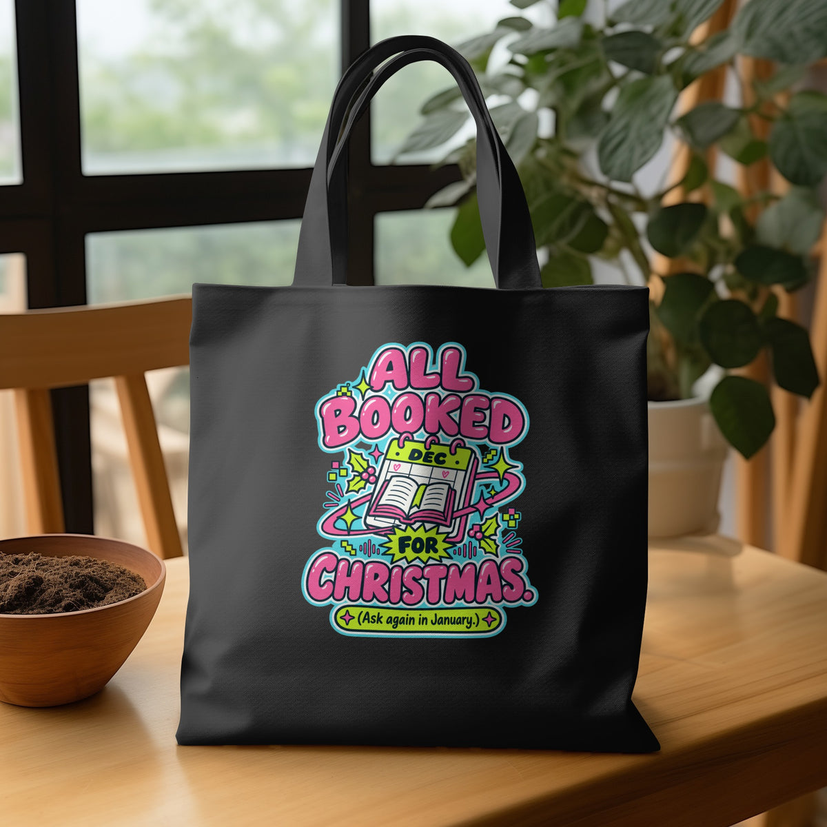 Black tote bag with "All Booked For Christmas (Ask again in January)" text.