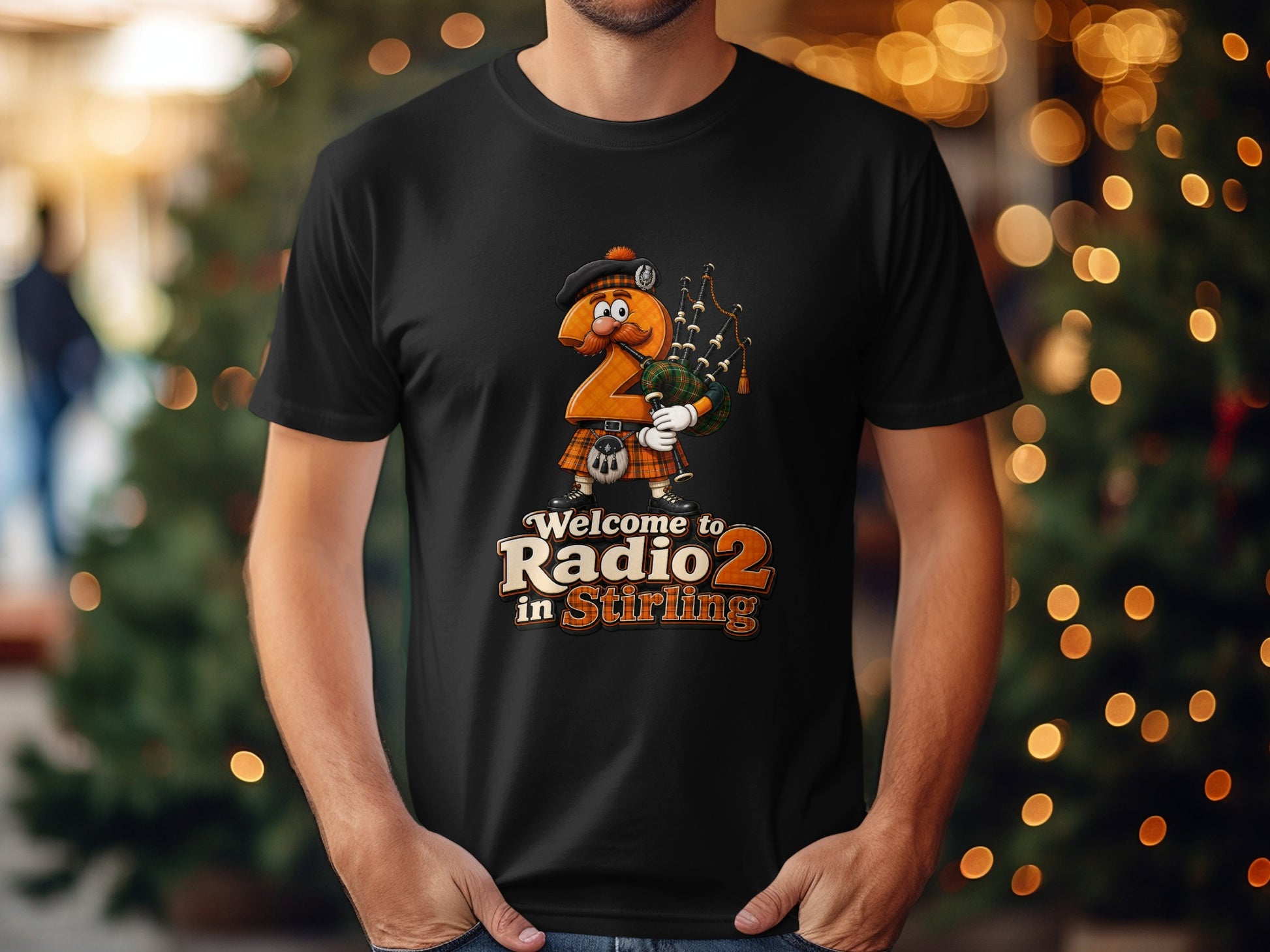 Cartoon bagpiper number 2 graphic on black t-shirt, "Welcome to Radio 2 in Stirling" text.
