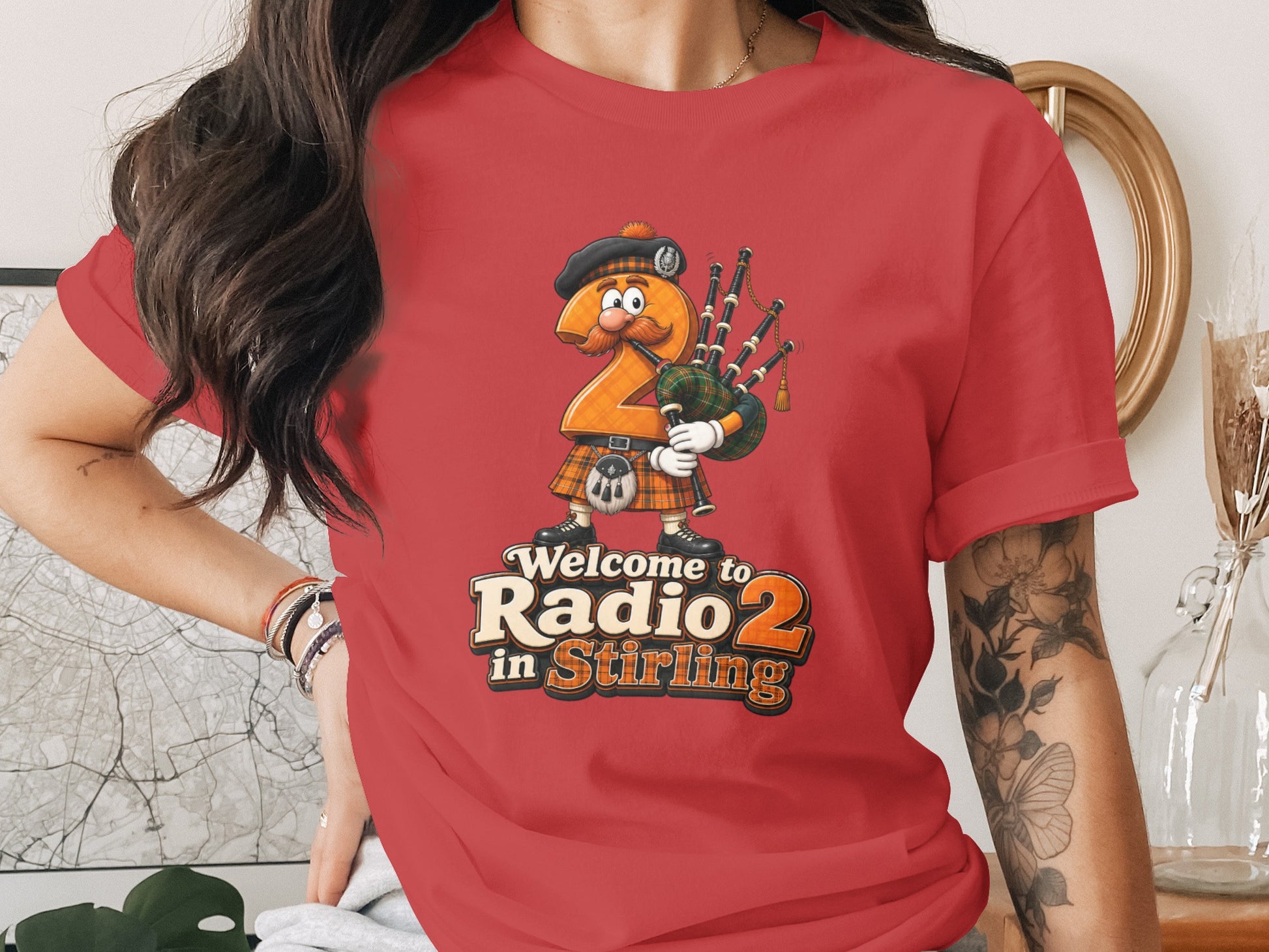 Red t-shirt with cartoon bagpipe-playing number 2 in kilt and text "Welcome to Radio 2 in Stirling".