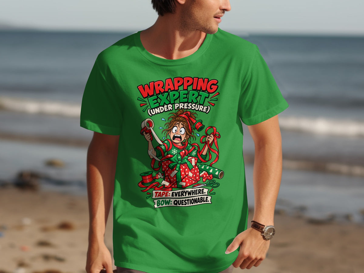Green t-shirt with a cartoon of a stressed person wrapping a gift, text reads "WRAPPING EXPERT".