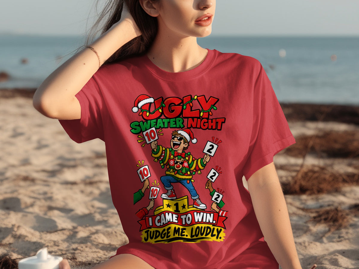 Red t-shirt with cartoon print of a man in an ugly sweater holding scorecards reading "Ugly Sweater Night".