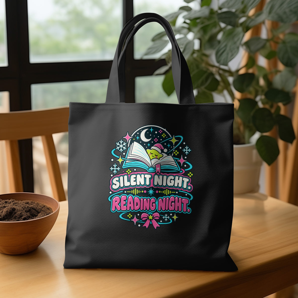 Black tote bag with "Silent Night Reading Night" text and starry reading-themed graphic.