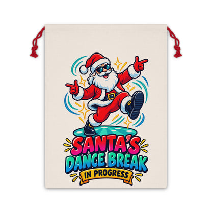 Santa's Dance Break in Progress text with cartoon Santa on a cream drawstring bag.