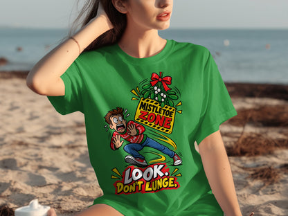 Green t-shirt with cartoon of man running from mistletoe, "Mistletoe Zone," and "Look. Don't Lunge."