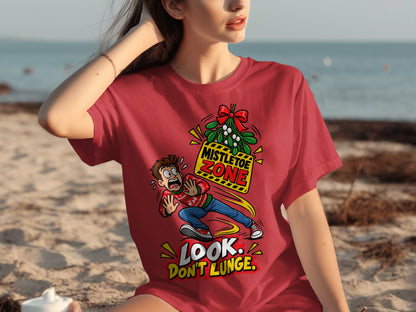 Red t-shirt graphic: man in festive sweater dodges mistletoe zone, text reads "Look. Don't Lunge."