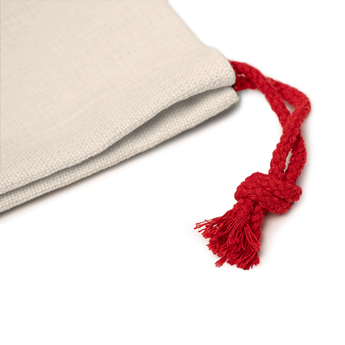 Cream fabric drawstring bag with a tied red cord and tassel on white background.