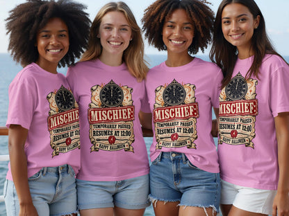 Four women wear pink t-shirts with "Mischief: Temporarily Paused Resumes at 12:00 Happy Halloween" graphic.