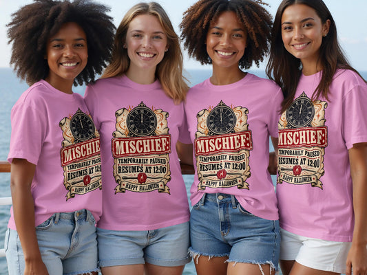 Four women wear pink t-shirts with "Mischief: Temporarily Paused Resumes at 12:00 Happy Halloween" graphic.